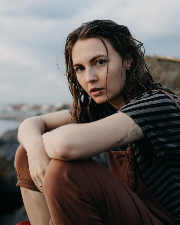 Wet Cold Woman Sitting On Beach