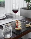Served table with wine glass and refreshment