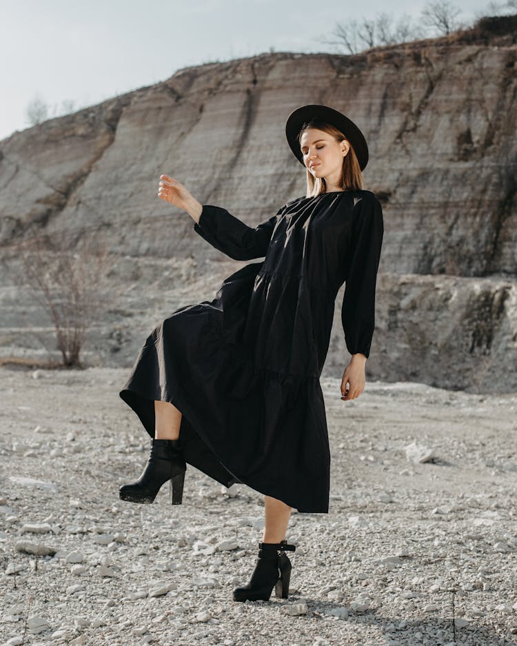 Stylish Woman In Black Dress Posing In Nature