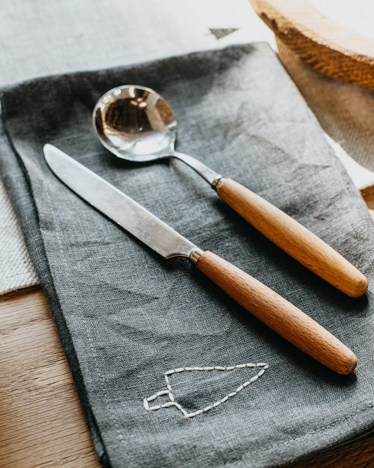 A Spoon And A Knife With Wooden Handle