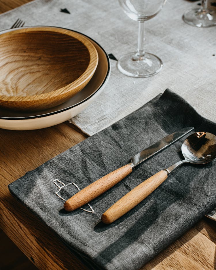 A Spoon And A Knife With Wooden Handle