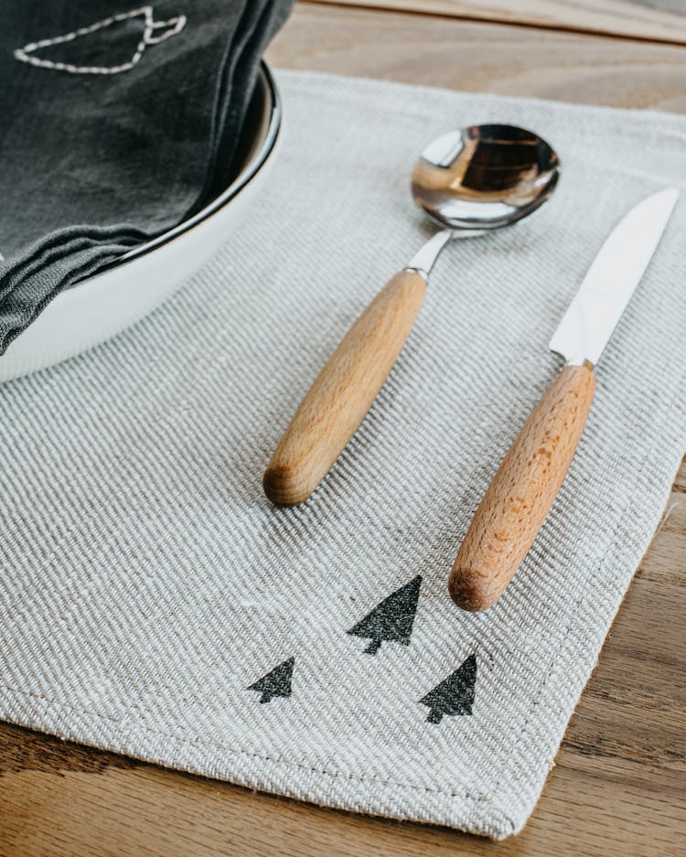 A Spoon And A Knife With Wooden Handle