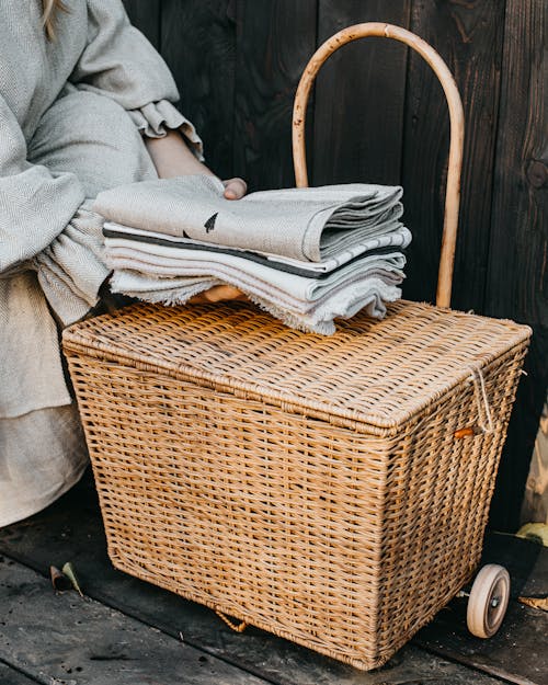 Hand Holding Fabrics over Basket