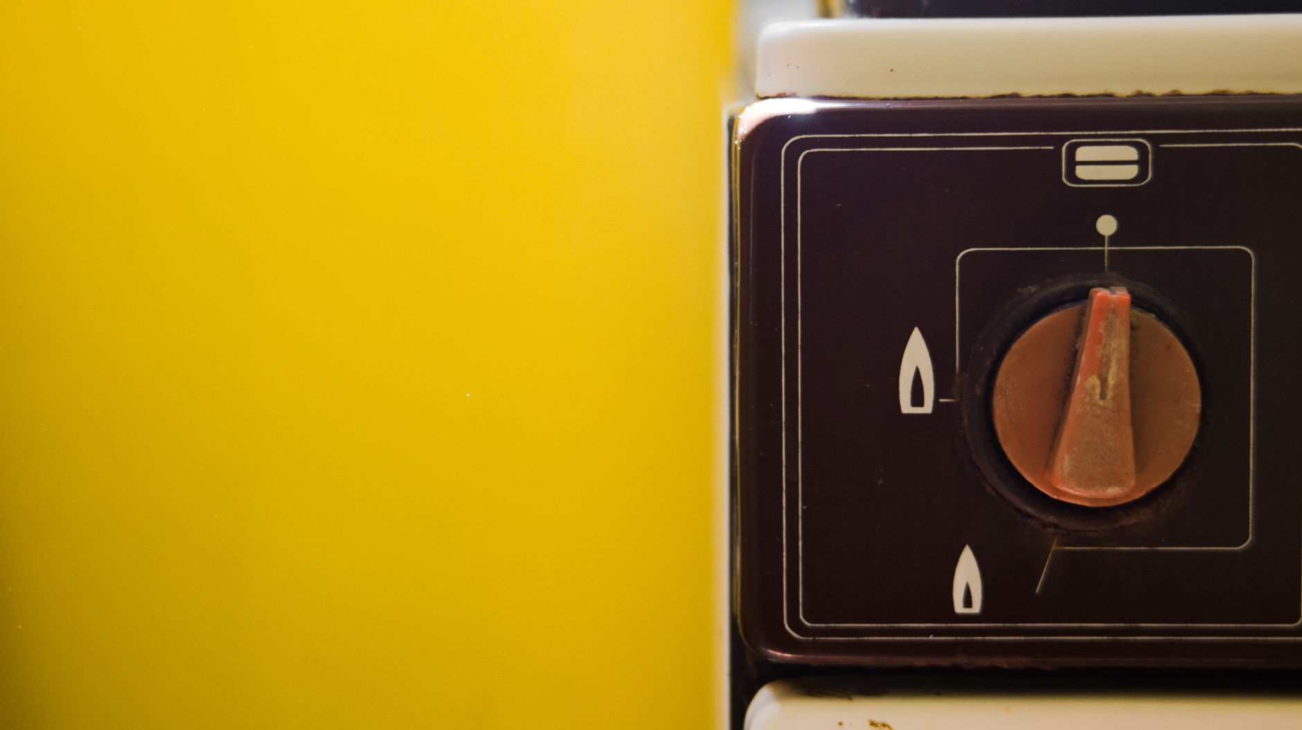 Warm wood cabinetry and retro lighting in a cozy 1970s style kitchen