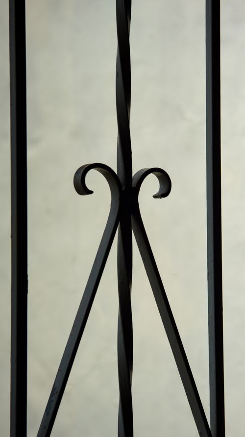 Free Detailed close-up of an elegant black iron railing with artistic design. Stock Photo