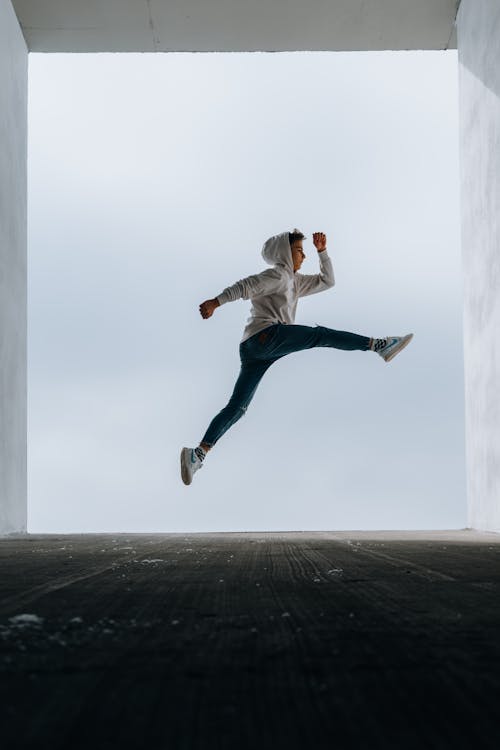 A Boy Wearing a Hoodie Jumping