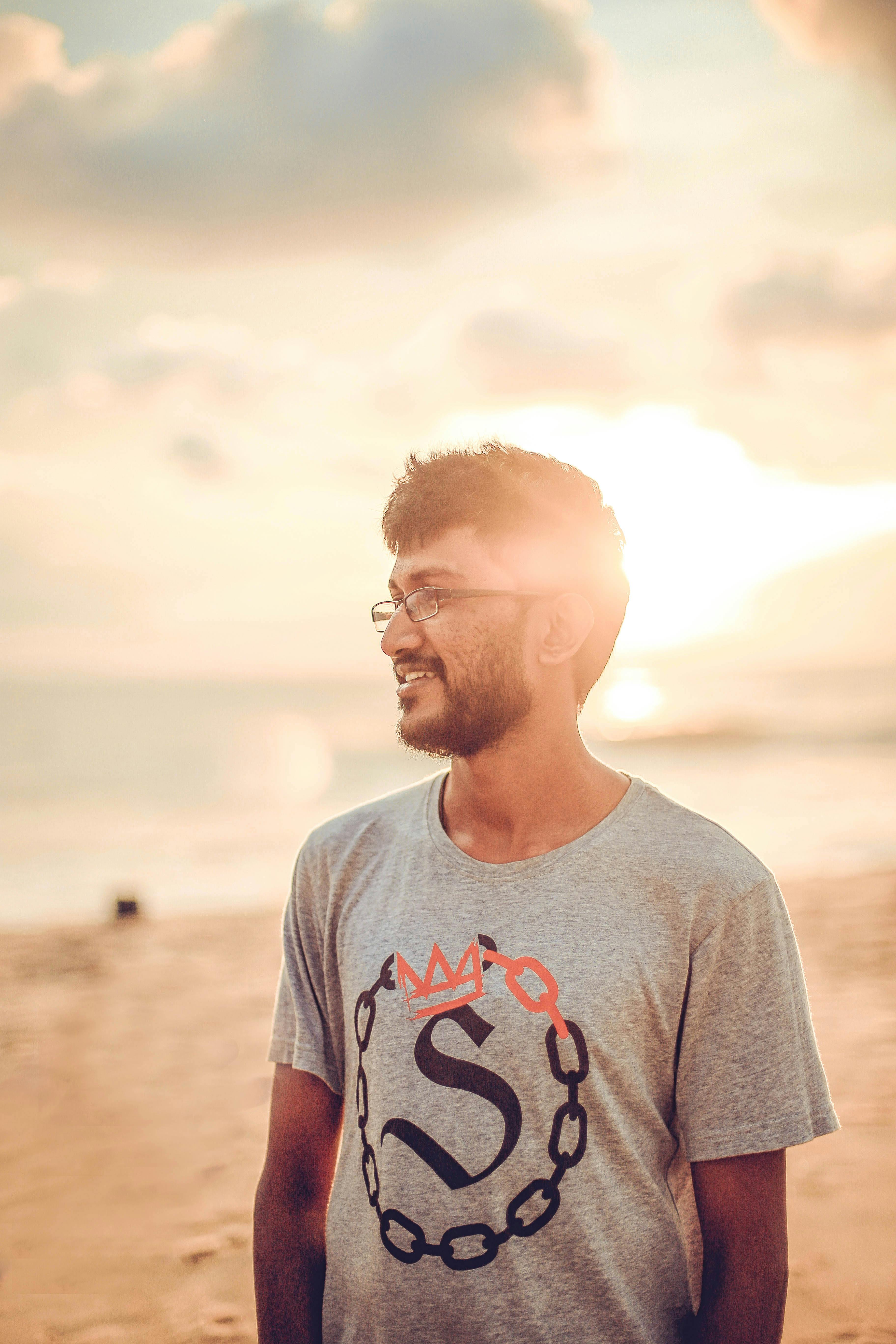 Man with glasses and beard enjoying a sunset on Wennappuwa Beach in Sri Lanka.