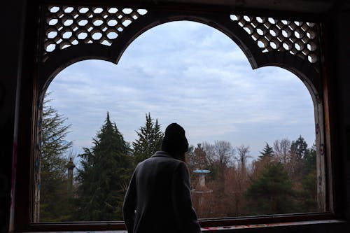 Silhouette of Person in an Arched Window