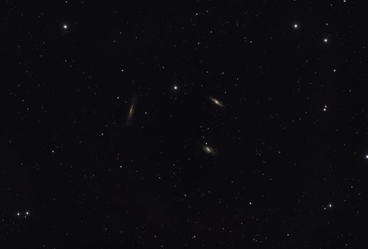A breathtaking view of distant galaxies amidst a starry night sky filled with countless stars.