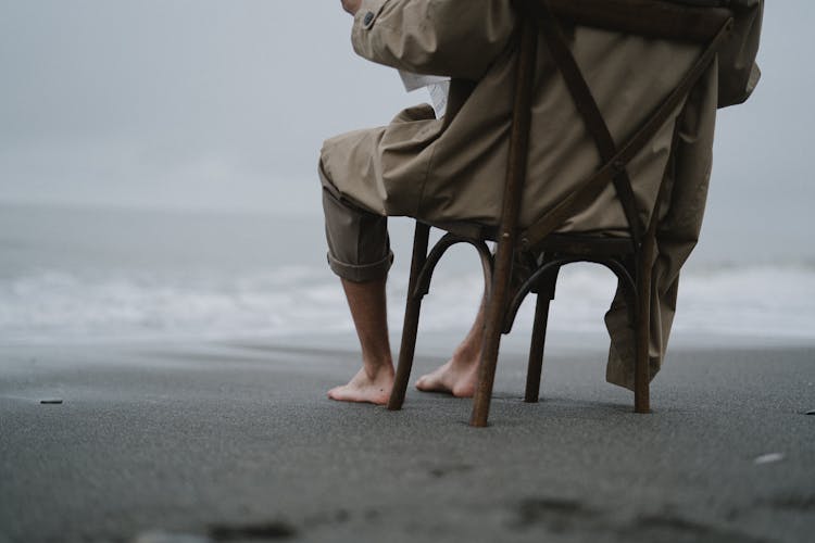 Person Sitting On Chair At The Beach