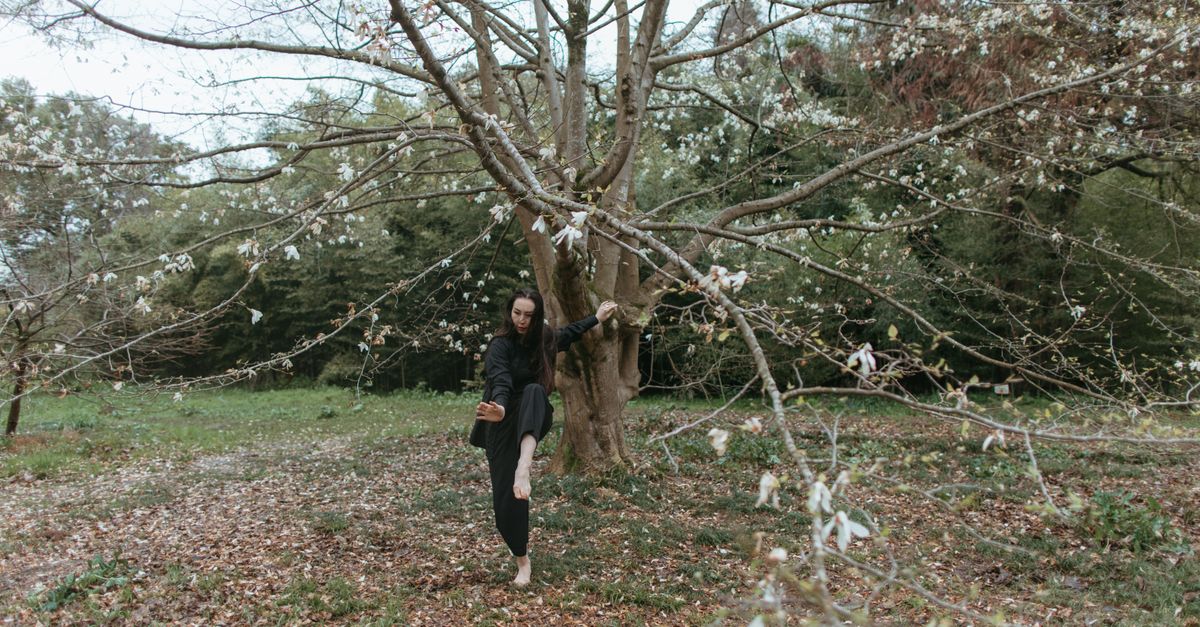 person walking barefoot in nature forest slow living mindfulness