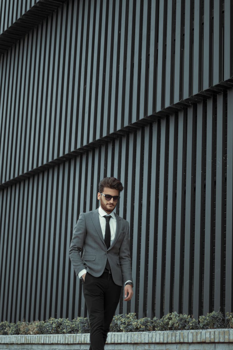 Stylish Man In Suit Walking On Street