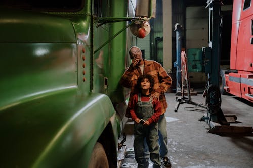 Father and Son Standing Beside a Truck