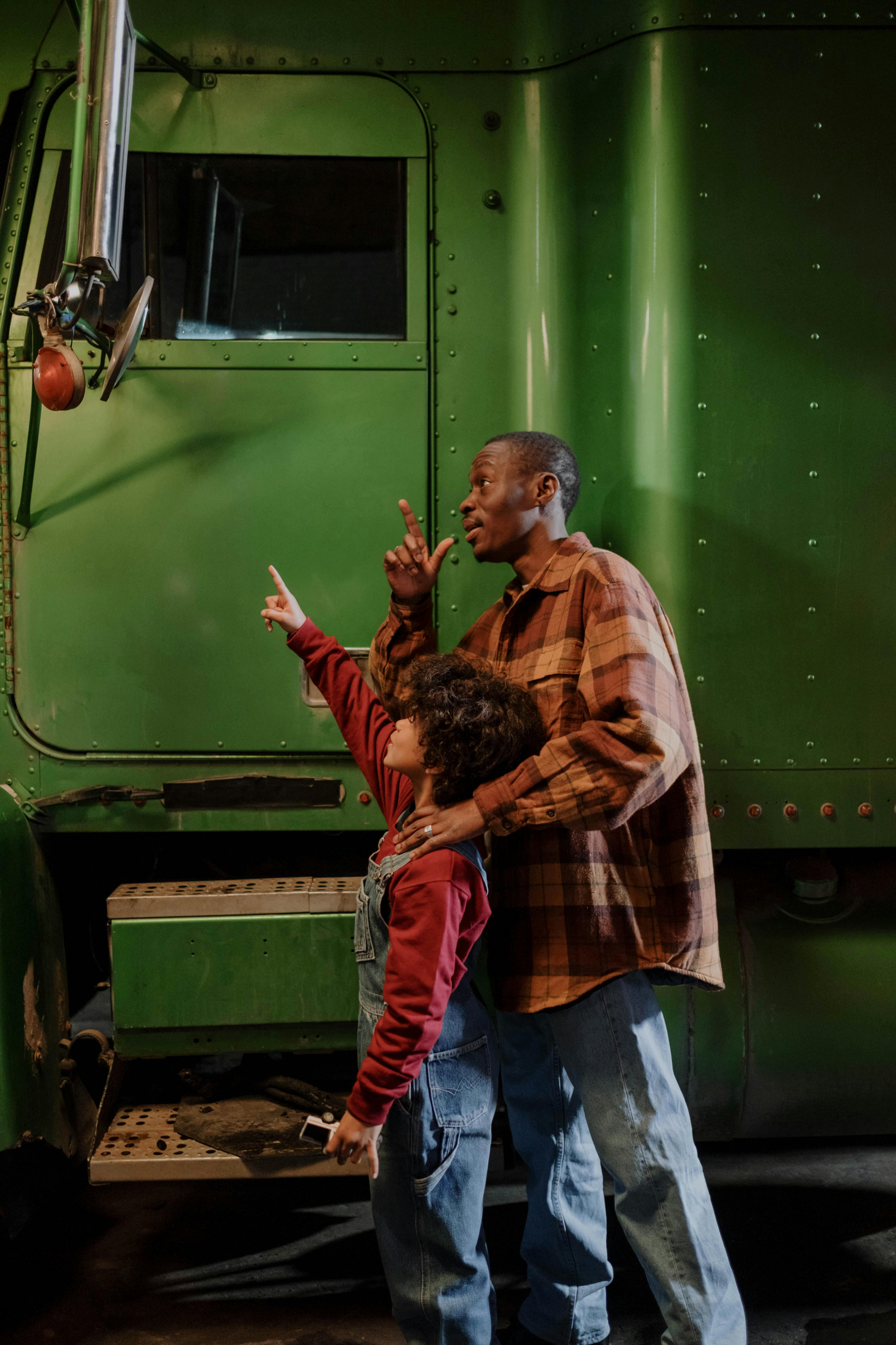 man-and-a-boy-standing-beside-a-truck-free-stock-photo