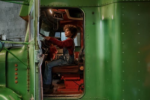 A Child Sitting in a Green Truck