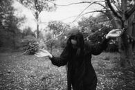 Woman in Black Jacket Holding a Fishing Rod