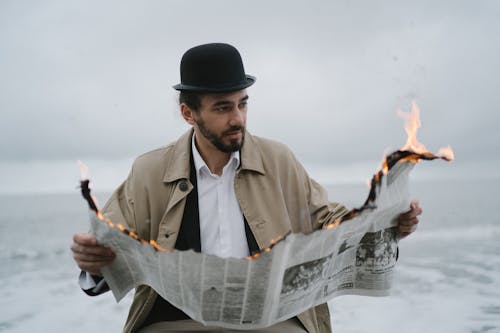 Free A Bearded Man Reading a Burning Newspaper Stock Photo