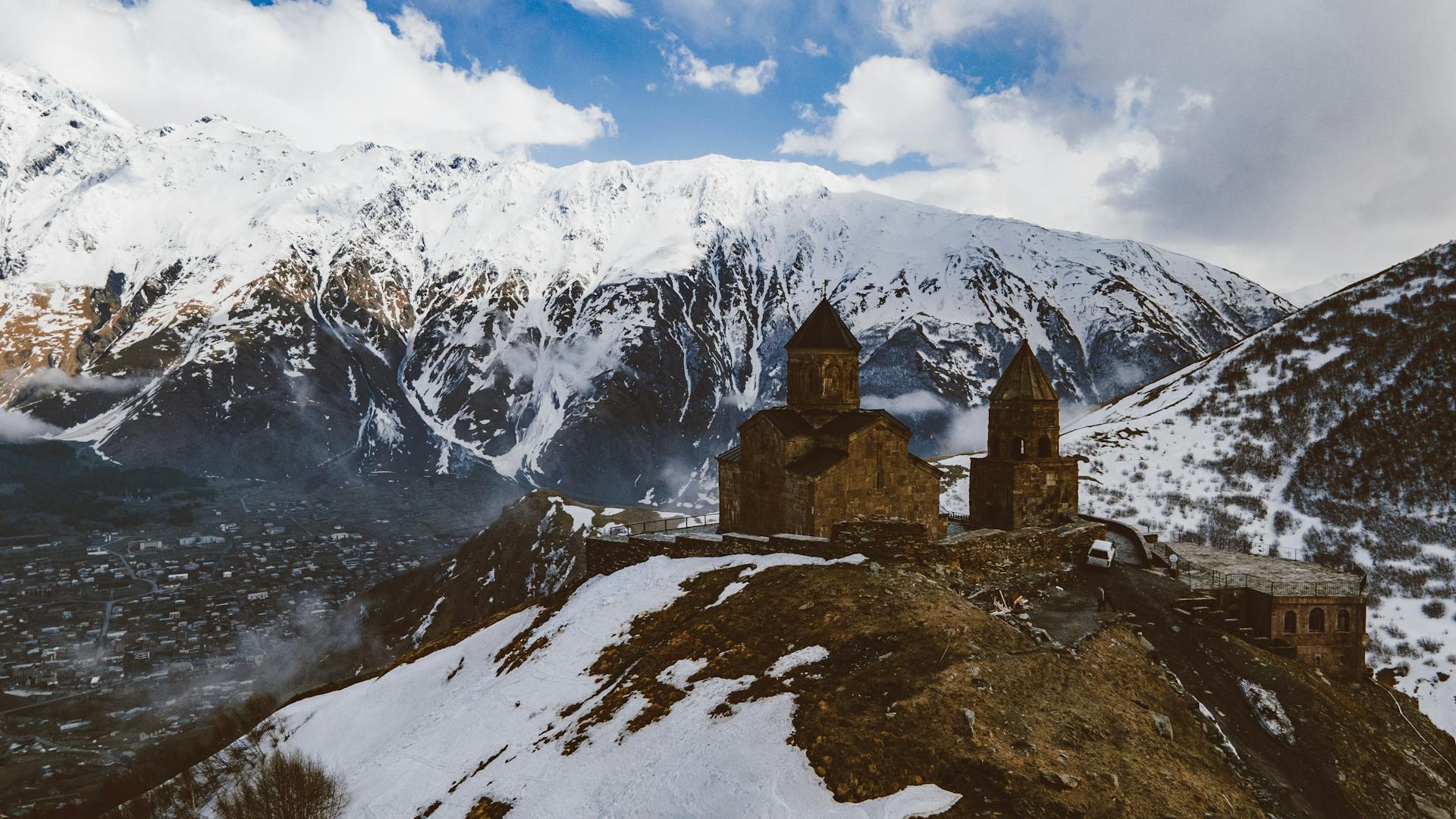 Brown Buildings of Church on the Snow Covered Mountain