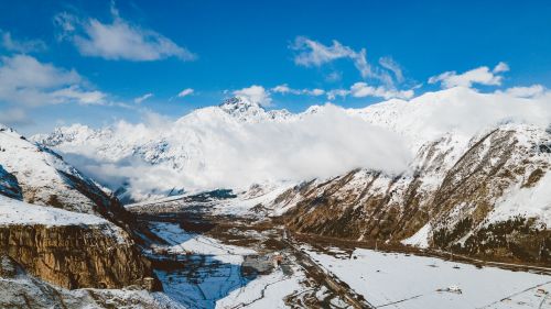 Free A stunning view of a snow-covered alpine mountain range under clear blue skies. Stock Photo