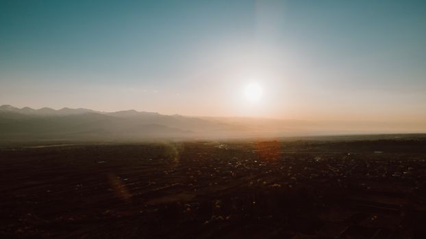 Peaceful aerial view capturing a serene sunrise over rural countryside.