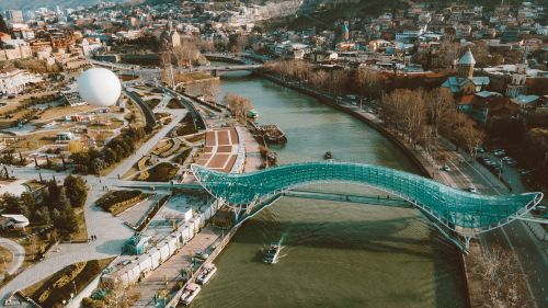 Free Aerial view of Peace Bridge over Kura River in Tbilisi, Georgia, showcasing urban landscape. Stock Photo