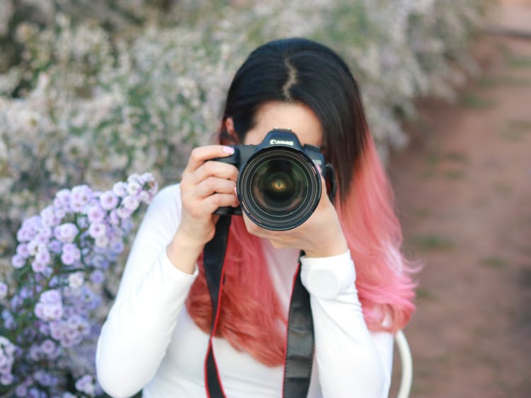 Portrait Of Woman With Pink Hair Taking A Picture With A Professional Camera 