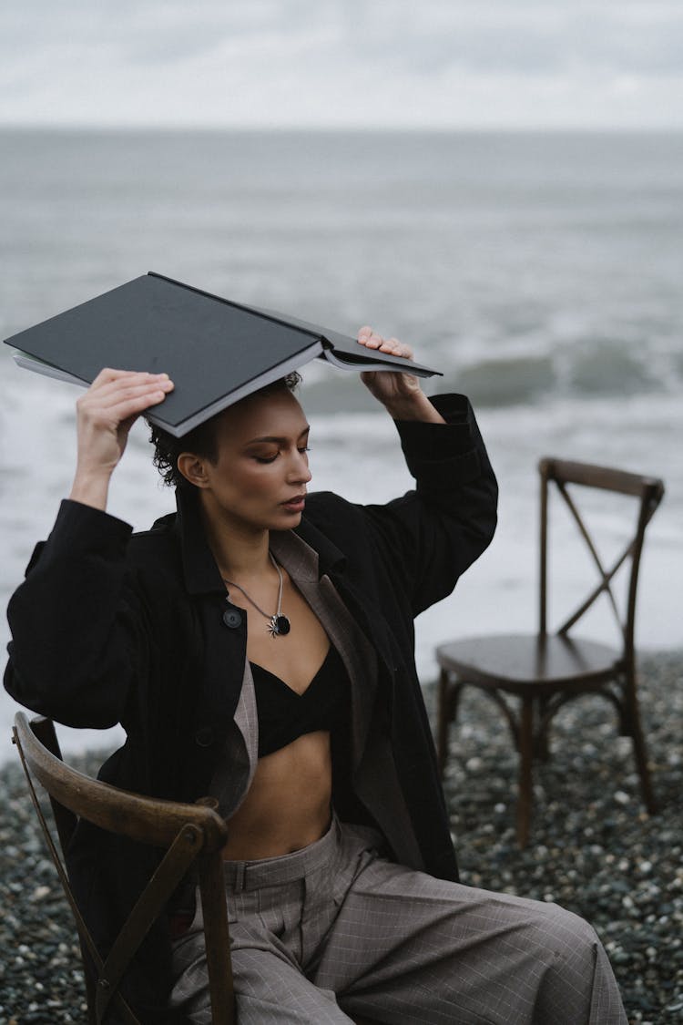 A Woman In Black Jacket Covering Her Head