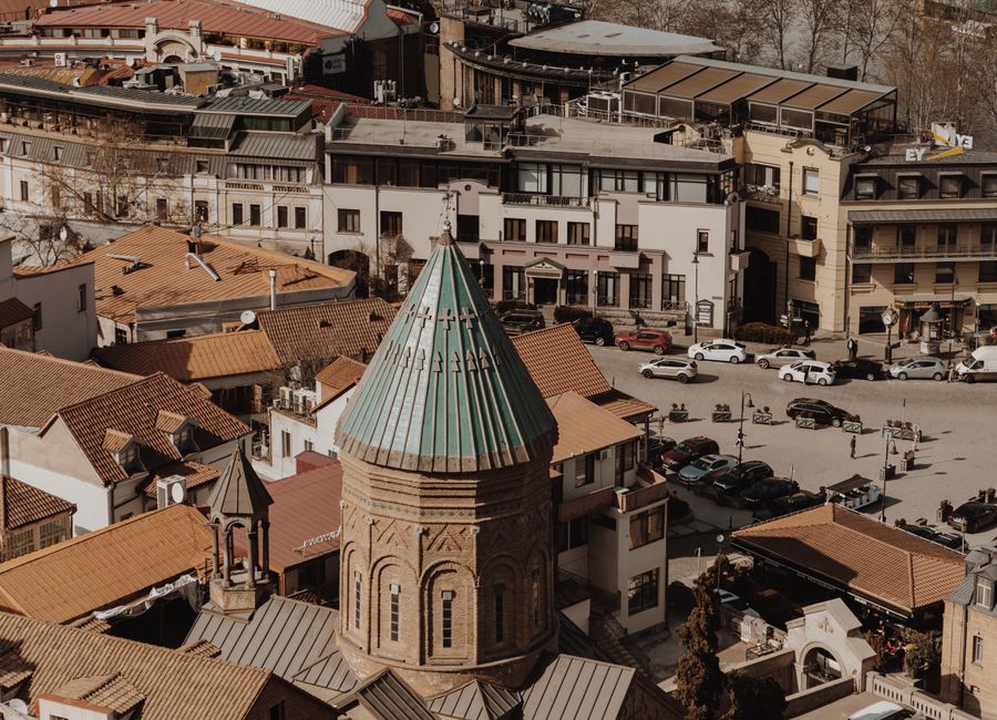 Aerial view of old town Tbilisi showcasing historic architecture and city life.
