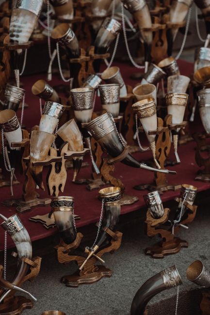 A variety of detailed, decorative drinking horns displayed elegantly, emphasizing craftsmanship.