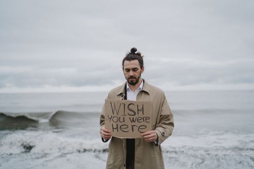 Man in Brown Coat Holding White and Black Paper
