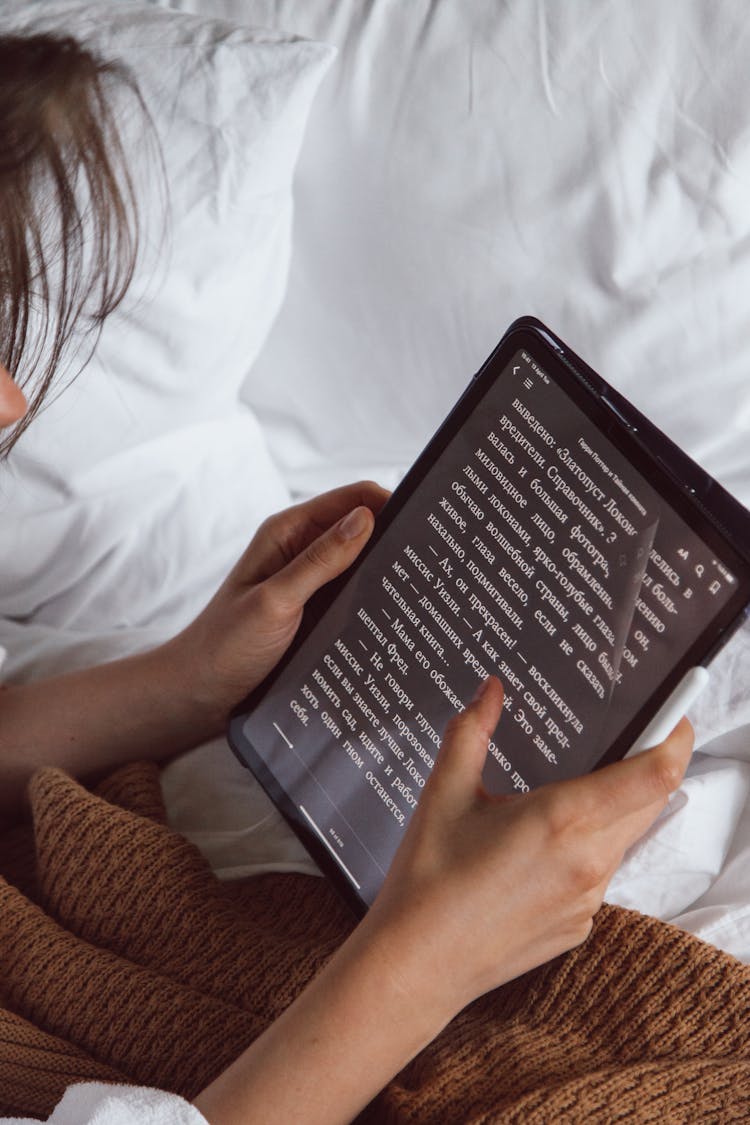 A Person Holding A Tablet