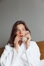 A Shocked Woman Using Telephone