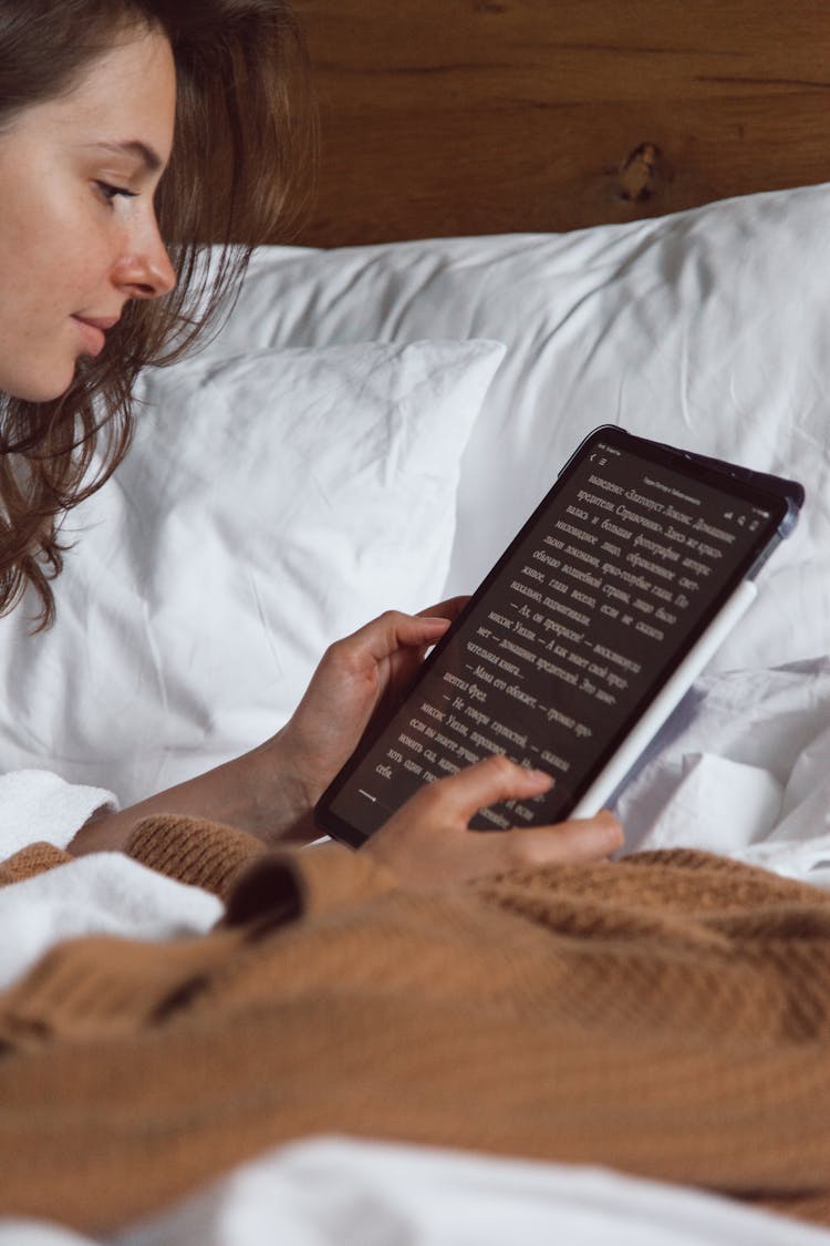 Woman Reading On Tablet