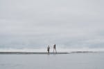 2 Women Standing on Beach