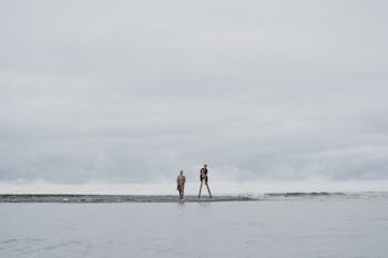 2 Women Standing on Beach