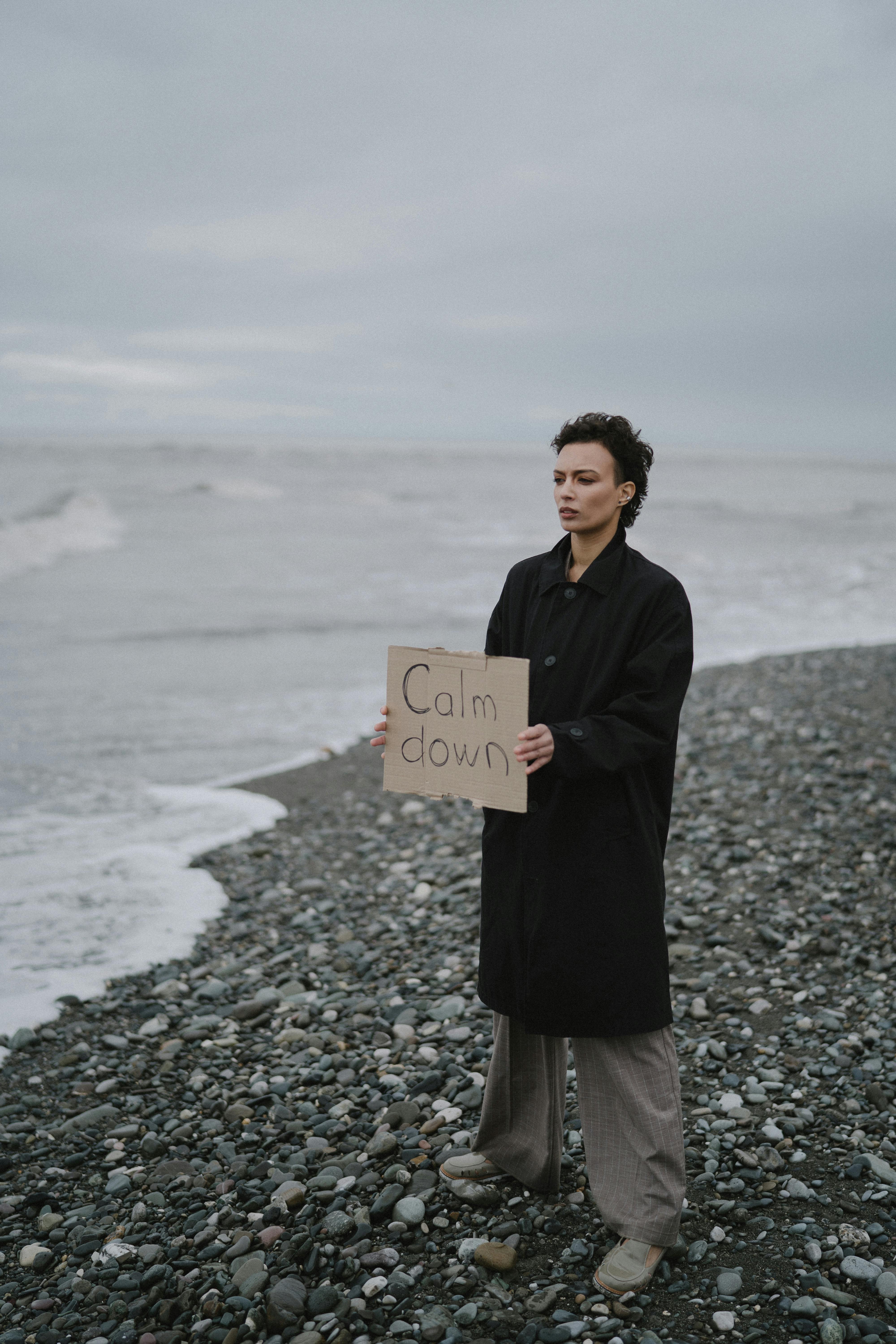 woman in black coat holding white paper