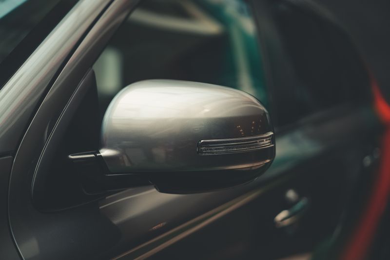 Close-up of a car's chrome side mirror
