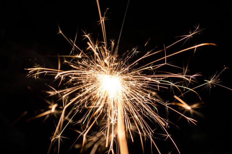 A bright firecracker lighting up a dark sky