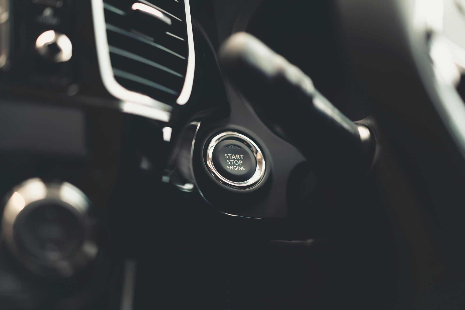 Close-Up Photo of a Car's Start and Stop Button