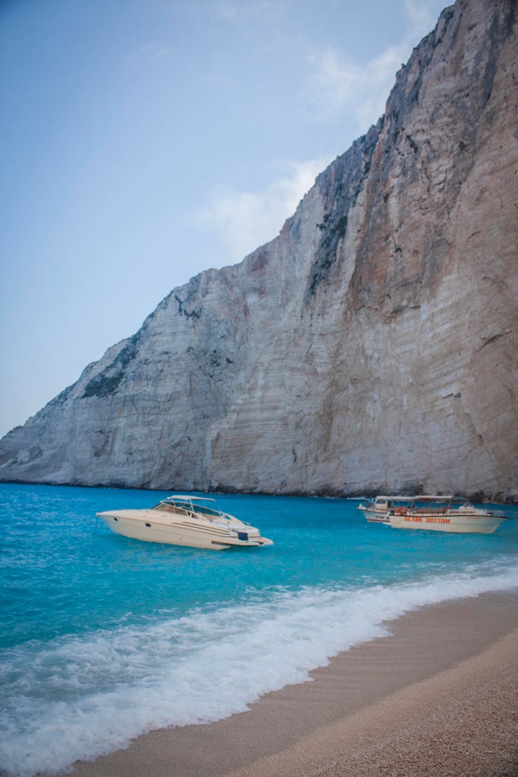 Photograph Of White Boats Near The Sand