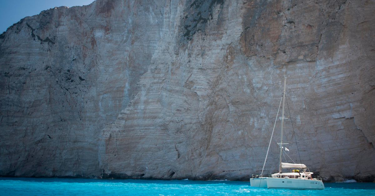 Sailboat Near the Cliff Rock · Free Stock Photo