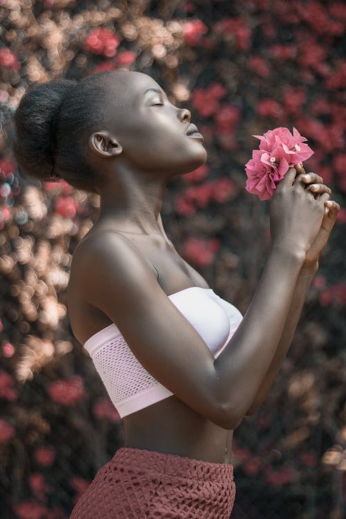 Woman with Eyes Closed Holding Pink Flowers