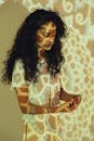 A Woman Standing in Front of a Projector Light
