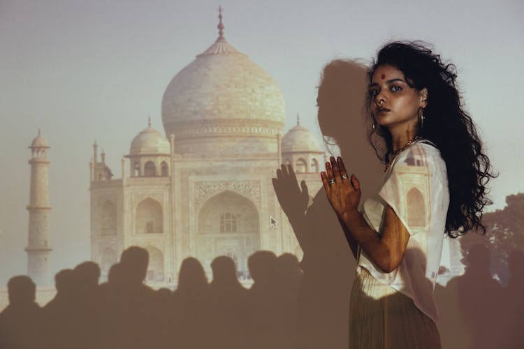 A Woman Standing Near The Wall With Mosque On A Projector