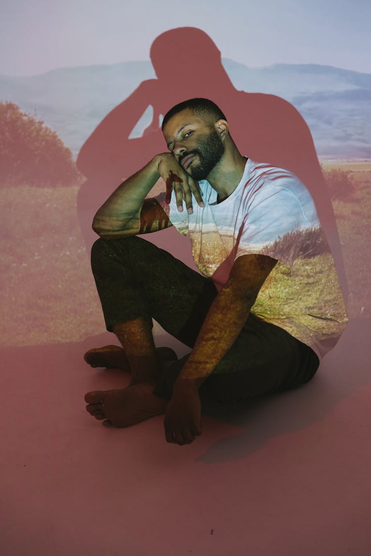 Projection Photography Of A Man Sitting On A Floor