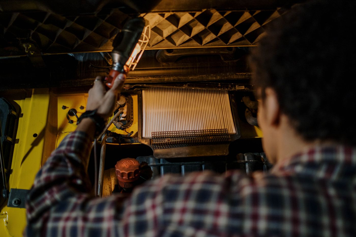 Mechanic inspecting forklift cooling system radiator