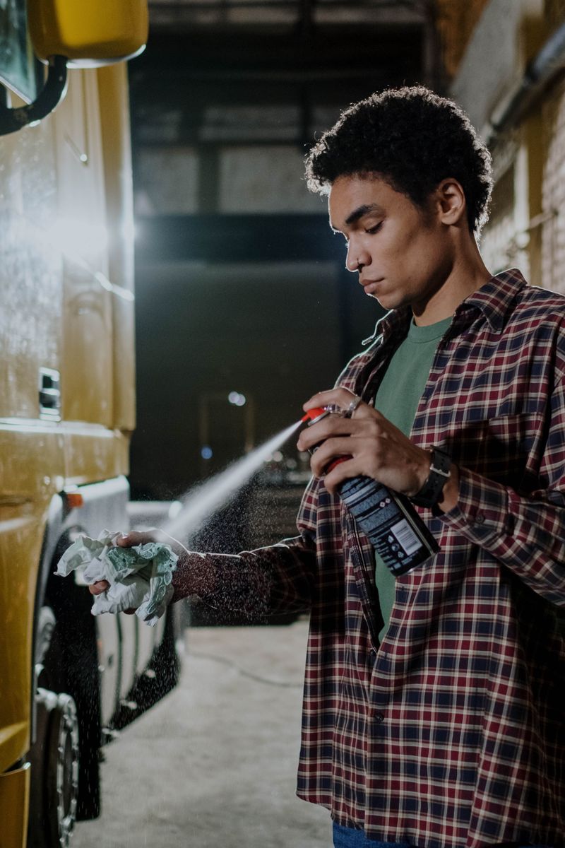 Man using spray can to clean a vehicle interior