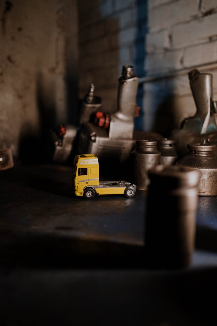 Photo Of Machine Parts With Small Yellow Toy Truck