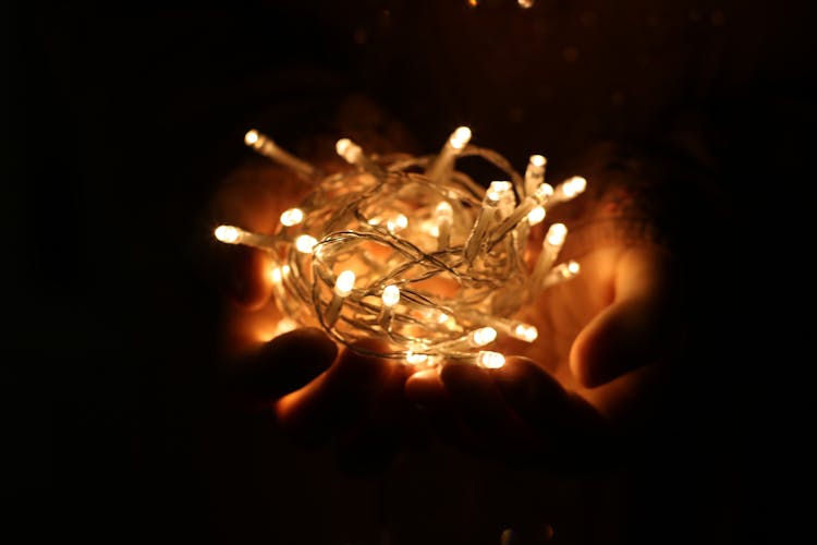 Person Showing White String Lights During Nightime