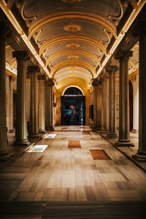 Free Interior of spacious empty corridor with tall columns on white floor and ornamental details on ceiling Stock Photo